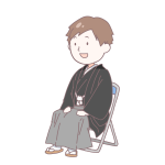 黒い袴を着て座っている成人男性